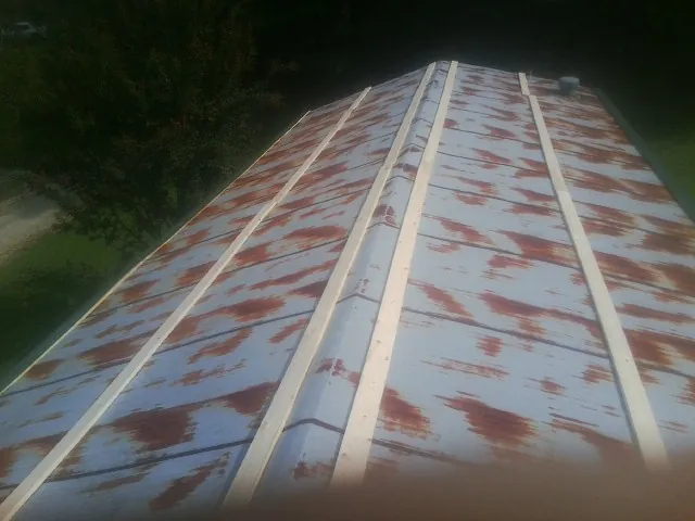 Rusted metal roof panels with new wood purlins before replacement — Storm Damage Roof Repair in Catawissa by Roofing Brothers