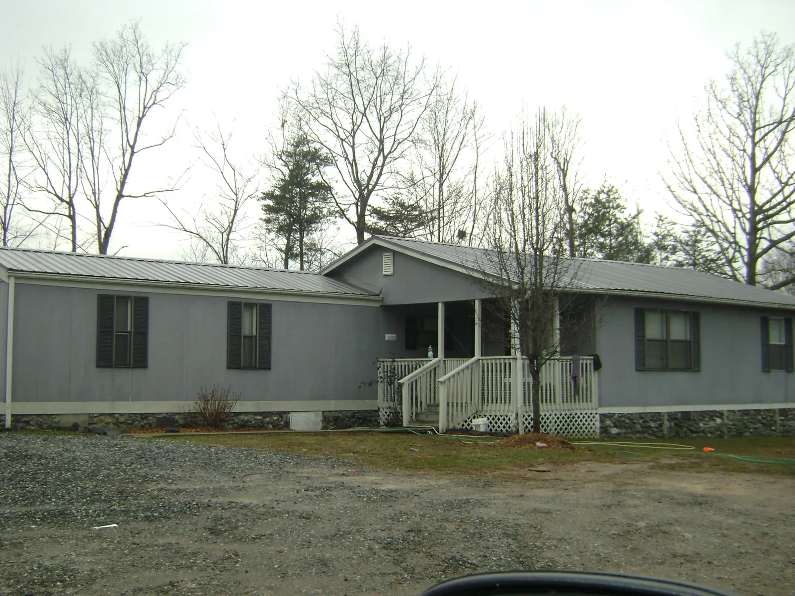 Metal roof over a manufactured home with a covered front porch in Catawissa